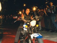 jean-claude-van-damme-in-leather-vest-on-harley-davidson-motorcycle-outside-planet-hollywood.jpg